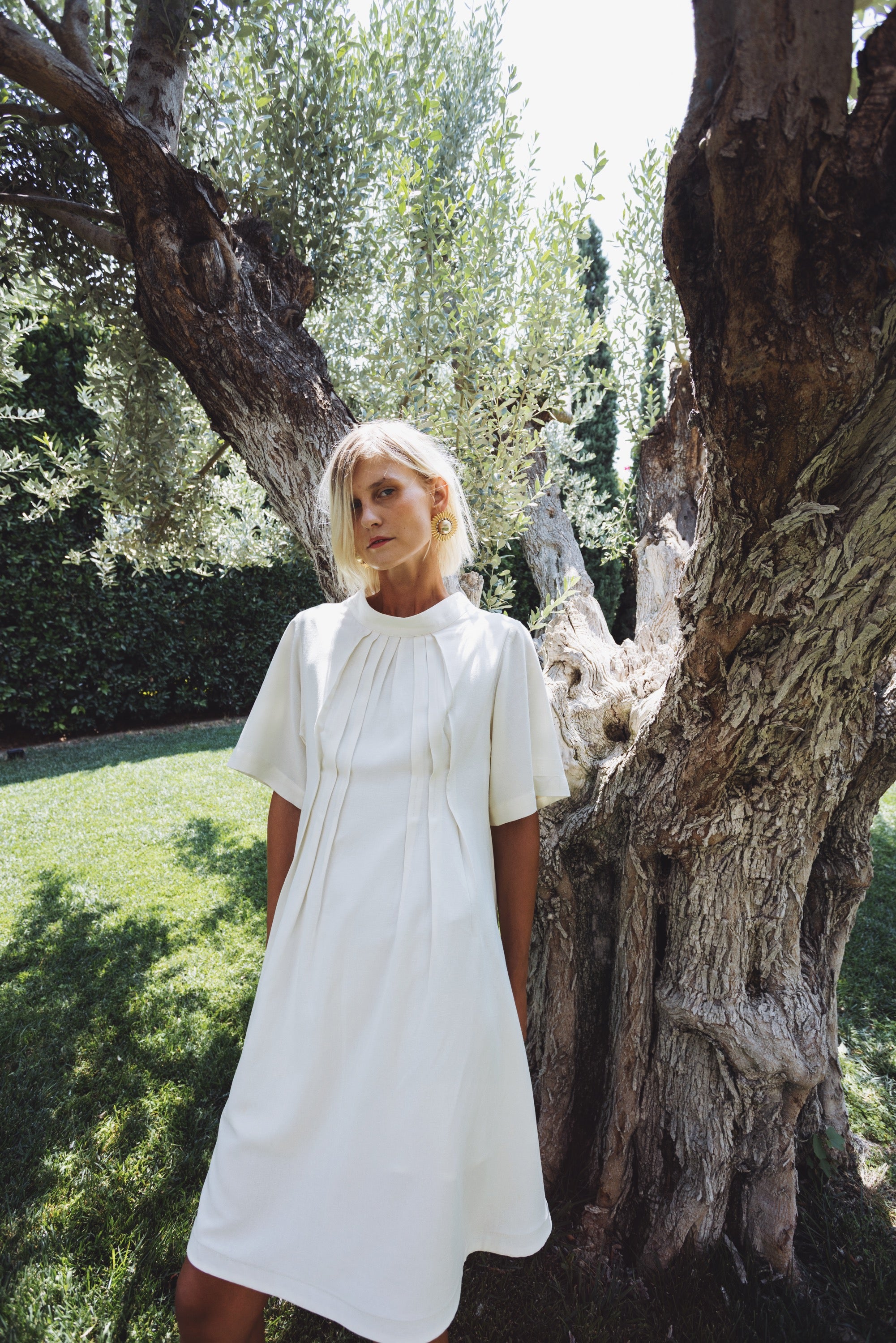 Cream linen-cotton dress with front pleats and relaxed silhouette
