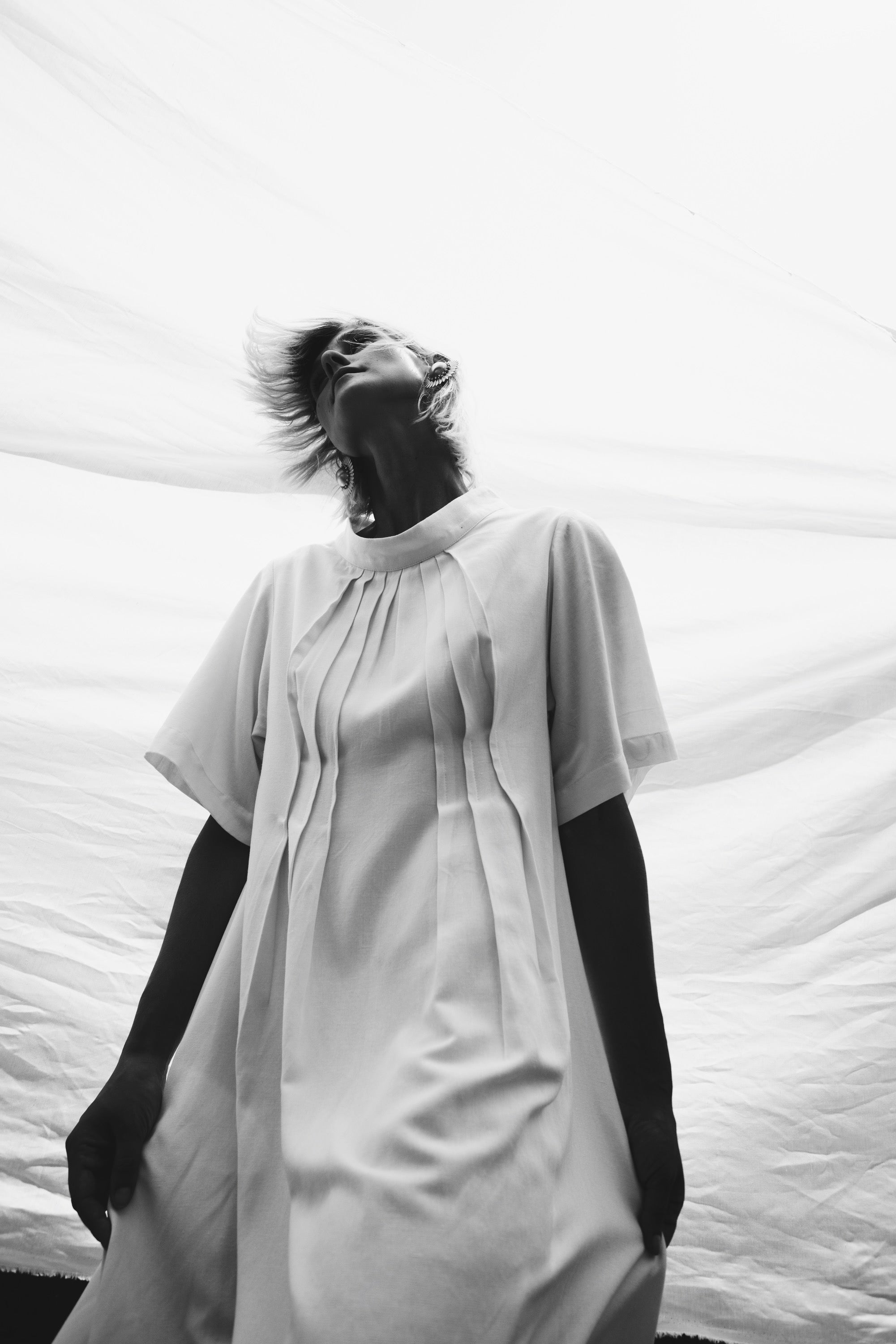 Cream linen-cotton dress with front pleats detail in monochrome lighting