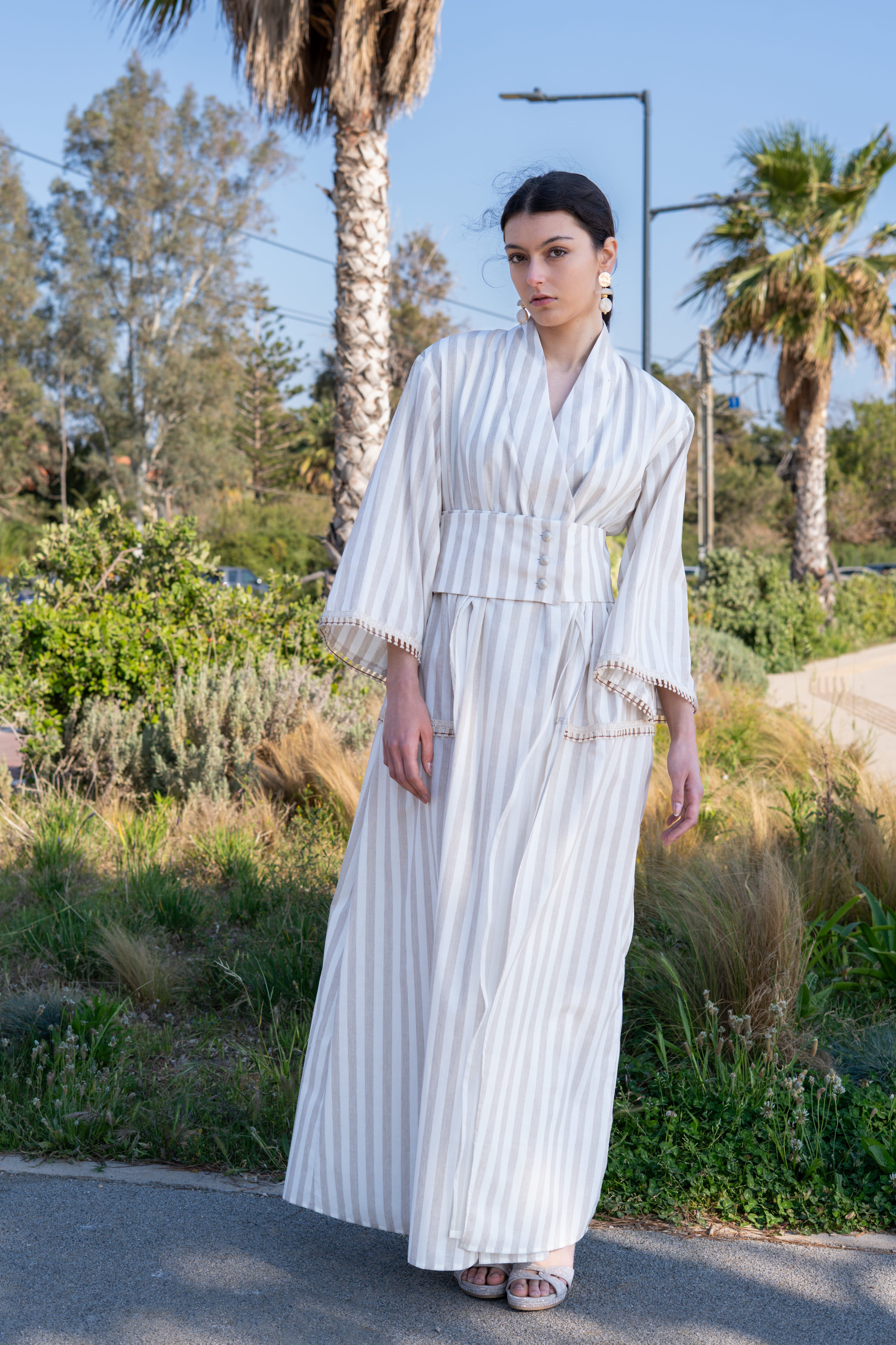 Striped cotton kimono dress full body front view with wide belt, long flowing skirt and relaxed sleeves, elegant summer look