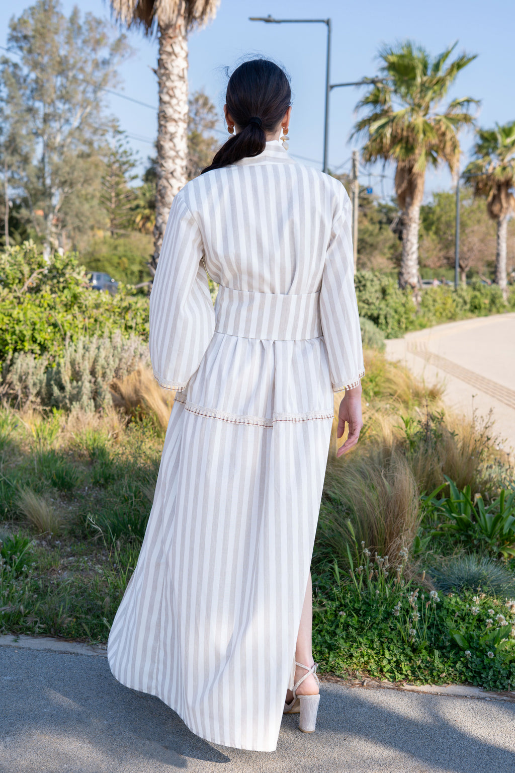 Striped cotton kimono dress back view outdoors with wide belt, flowing skirt and natural movement, full length silhouette