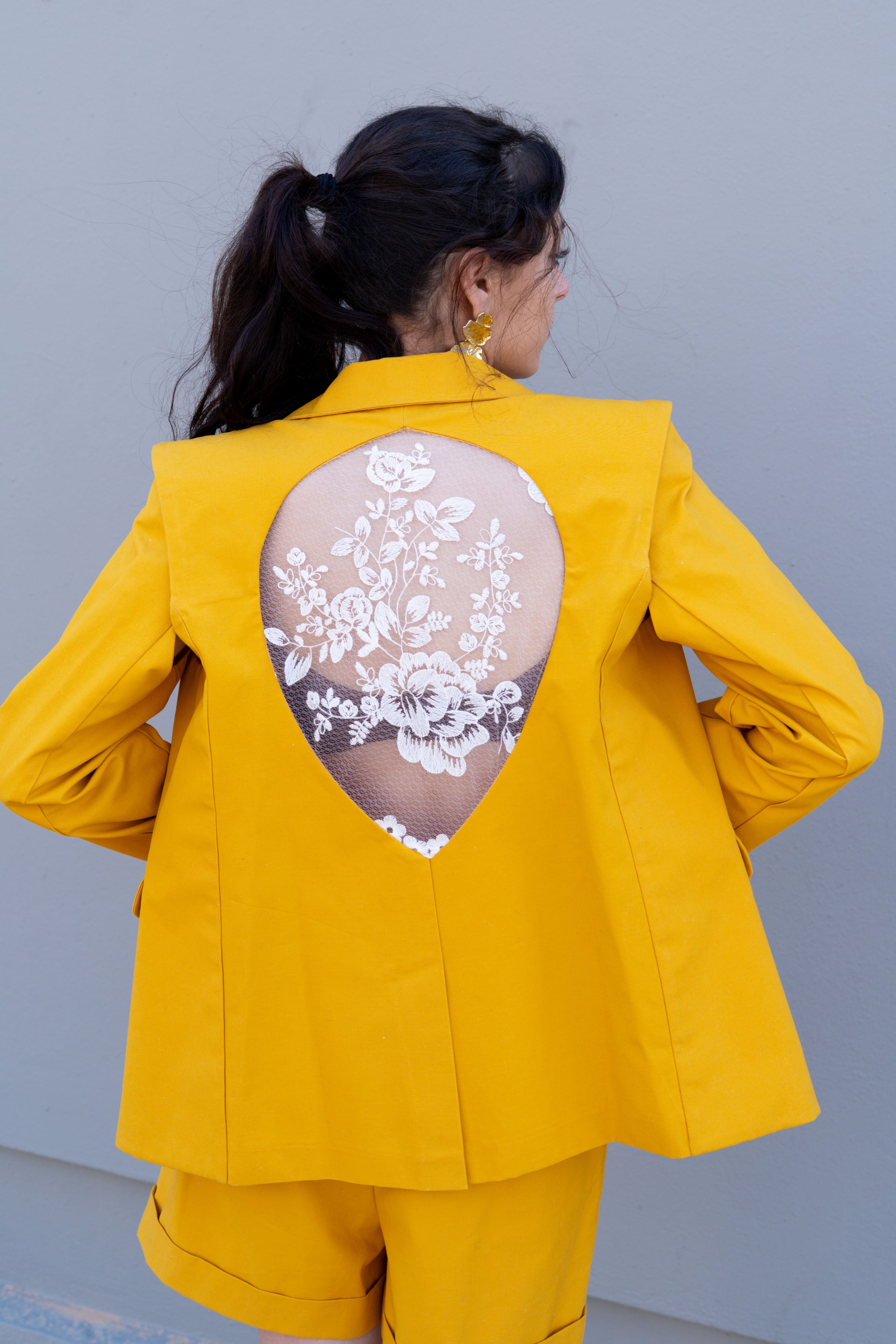 canary yellow tailored blazer with detachable sleeves open back teardrop cutout and floral lace back view