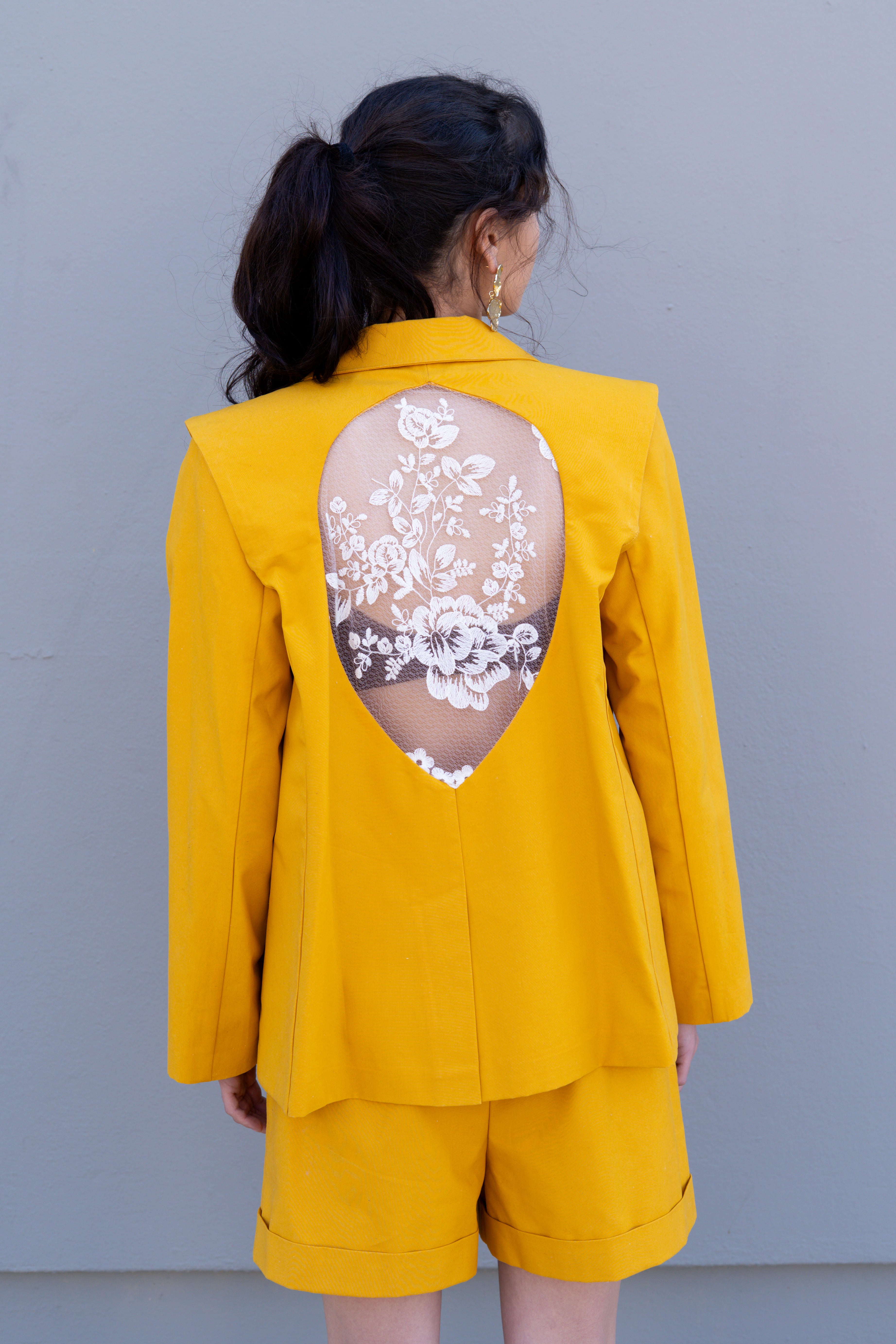 canary yellow tailored blazer with detachable sleeves open back teardrop cutout and embroidered floral lace detail