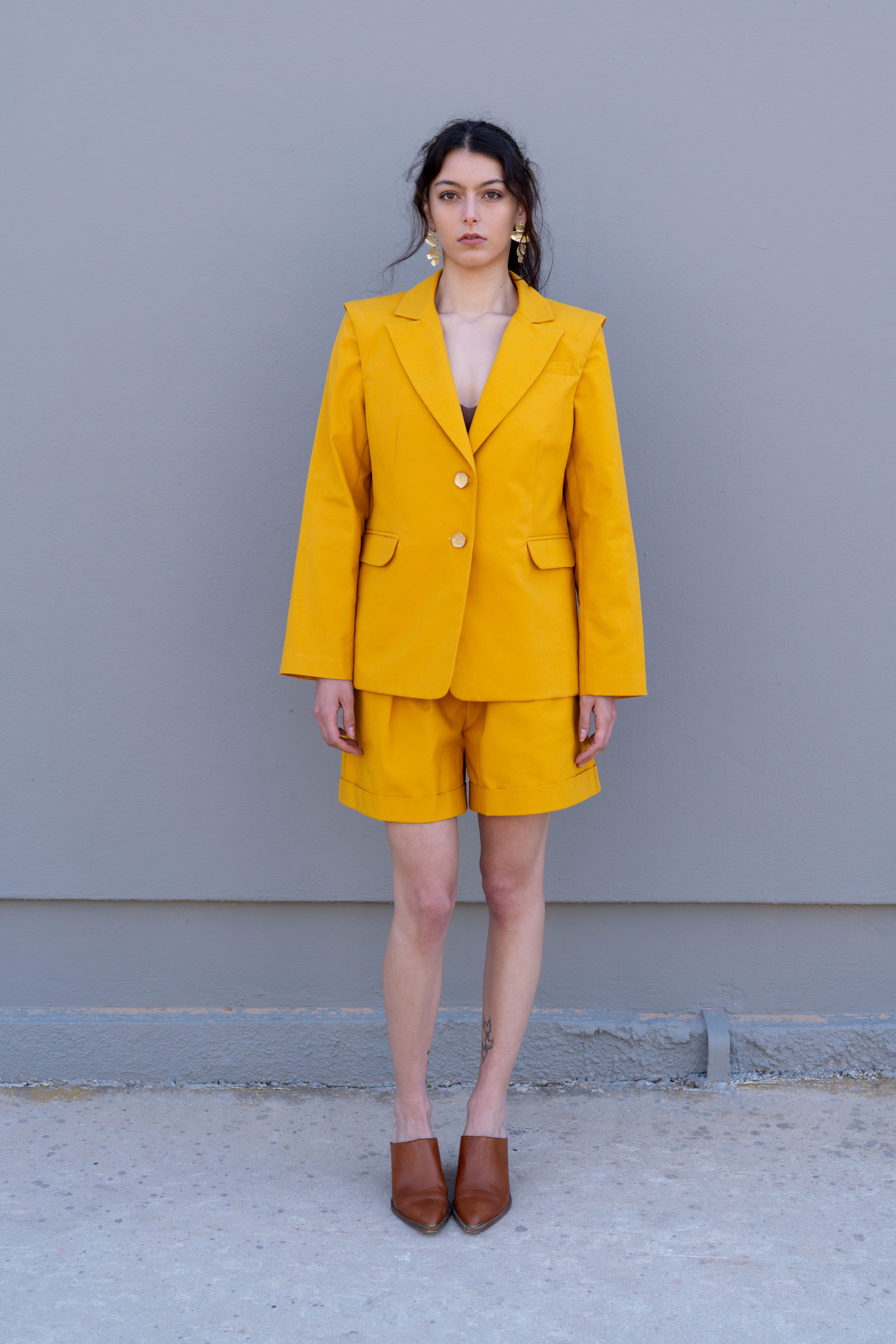 canary yellow tailored blazer with structured shoulders front full body view styled with matching bermuda shorts
