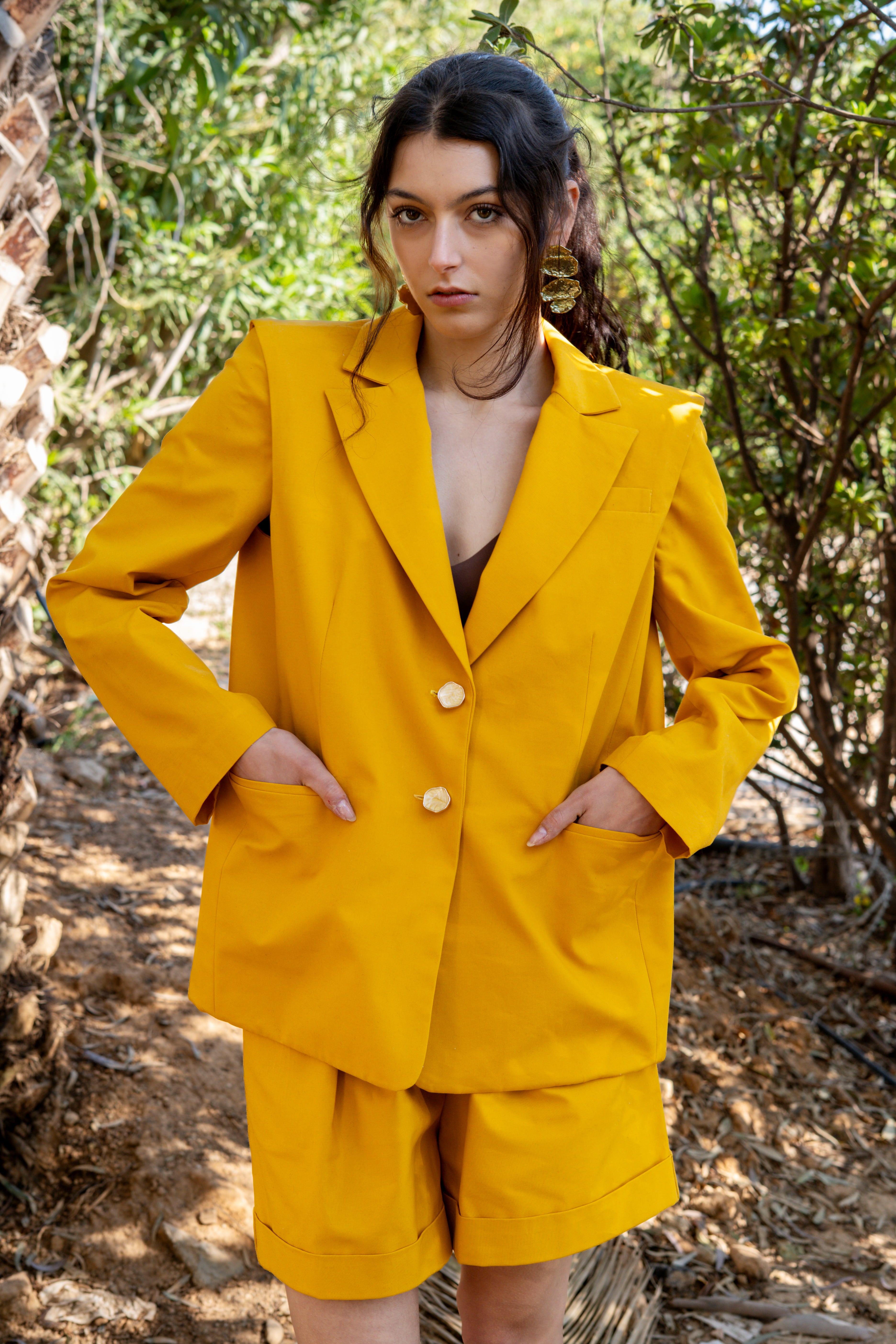 canary yellow tailored blazer front view outdoors with matching bermuda shorts and pockets detail