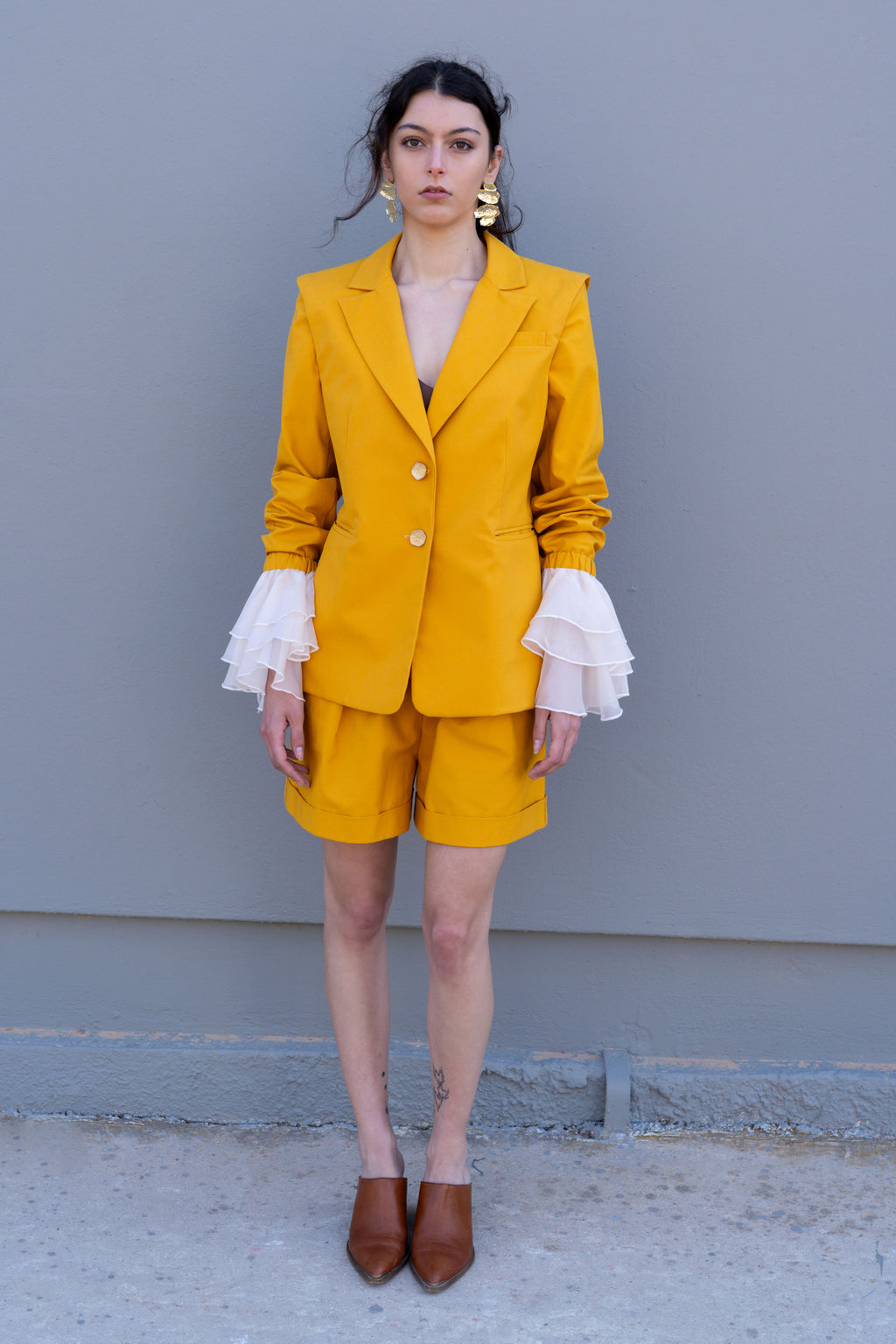 canary yellow tailored blazer with detachable sleeves and organza ruffle cuffs front view