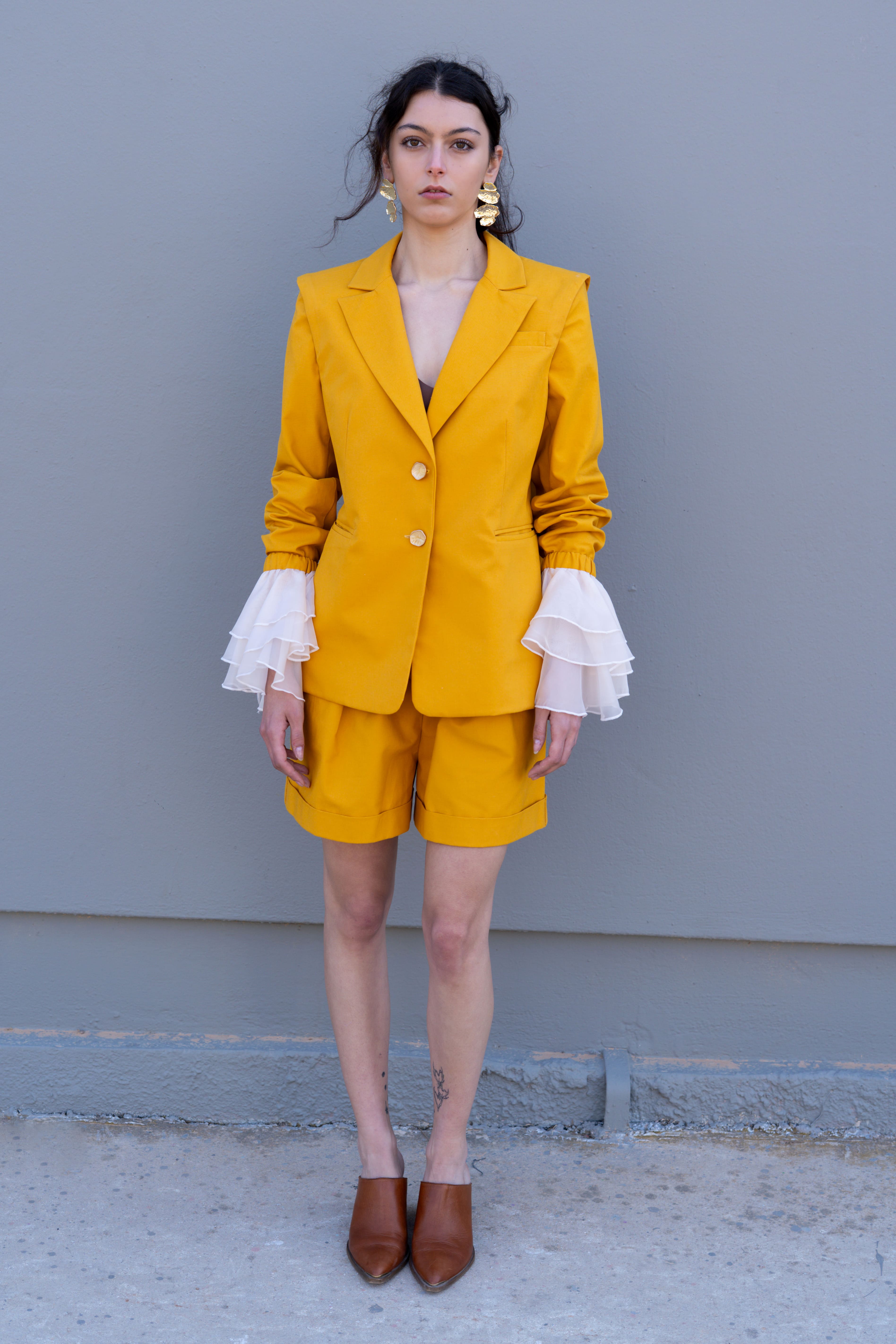 canary yellow tailored blazer with detachable sleeves and organza ruffle cuffs front view
