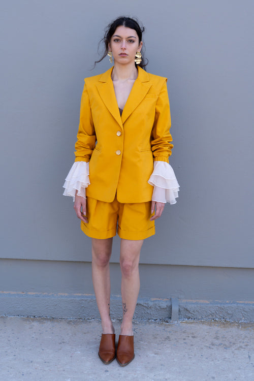 canary yellow tailored blazer with detachable sleeves and organza ruffle cuffs front view