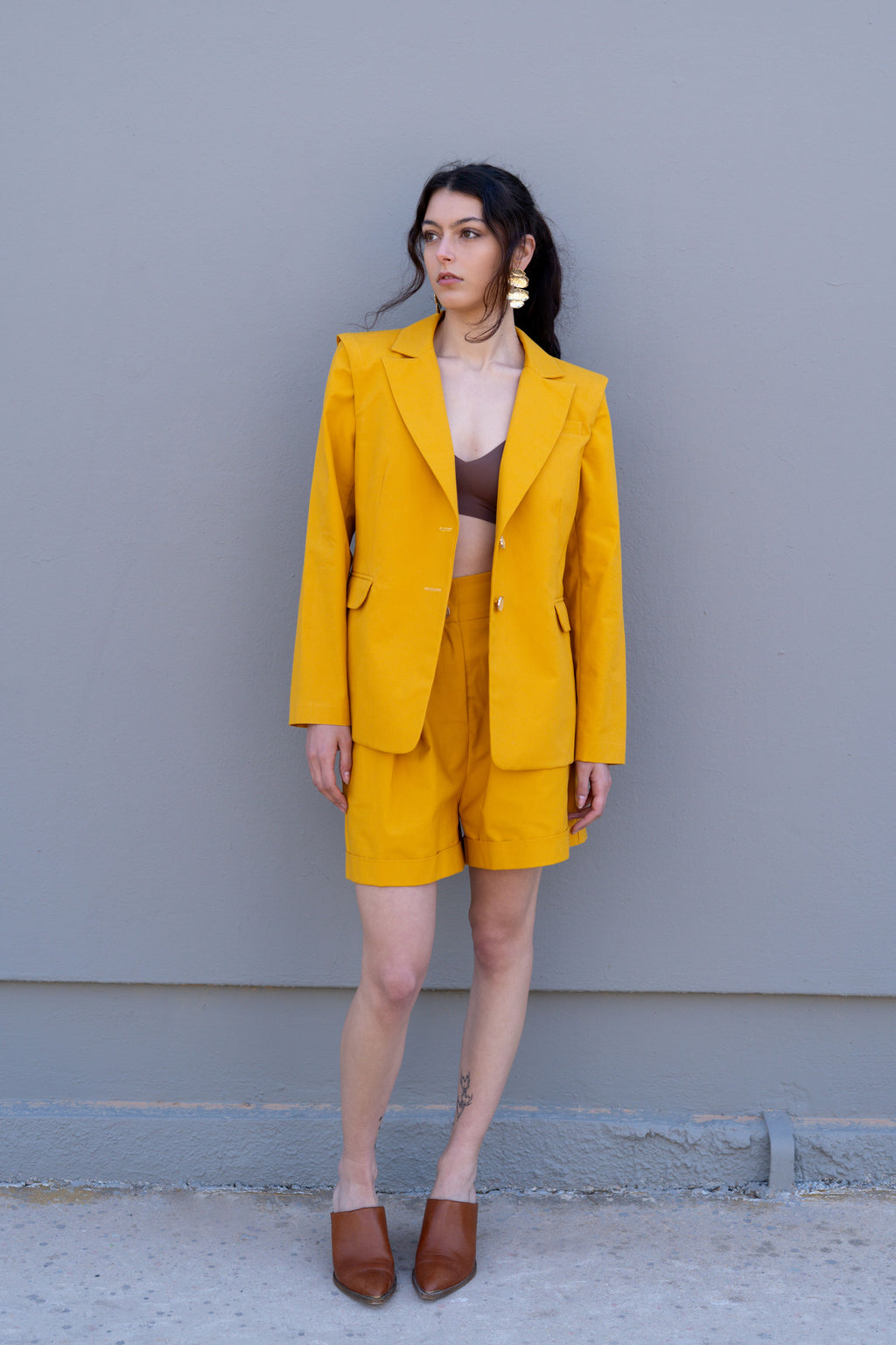 canary yellow tailored blazer front full body look with matching bermuda shorts clean styling