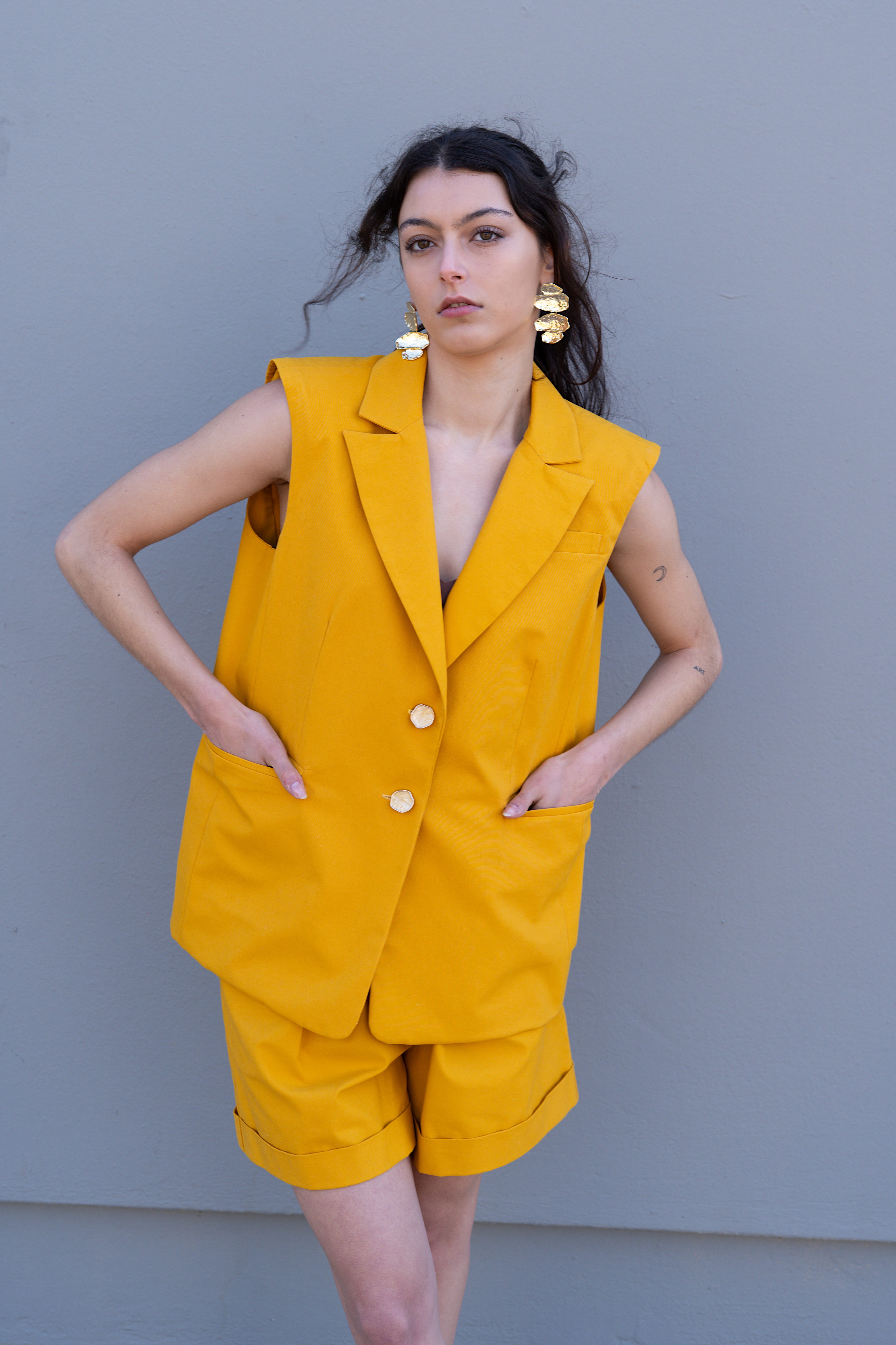 canary yellow sleeveless blazer with front pockets and chest pocket oversized tailored vest front view