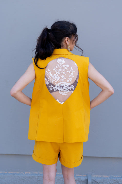 Canary yellow tailored vest with open back lace panel detail, structured shoulders and relaxed fit, back view