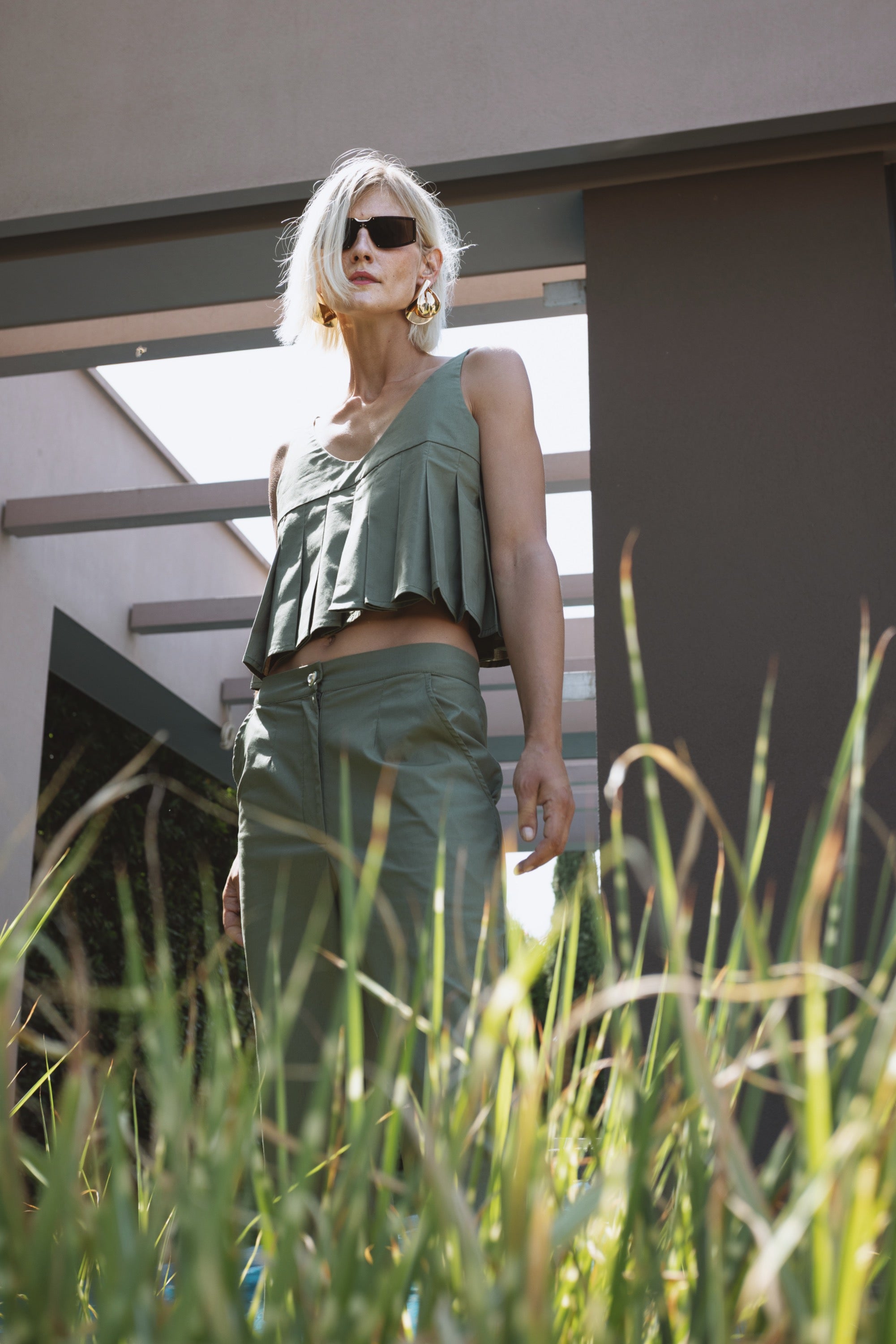 Julia Valas Elia Top with olive capri trousers matching set in natural light with soft summer atmosphere outdoors