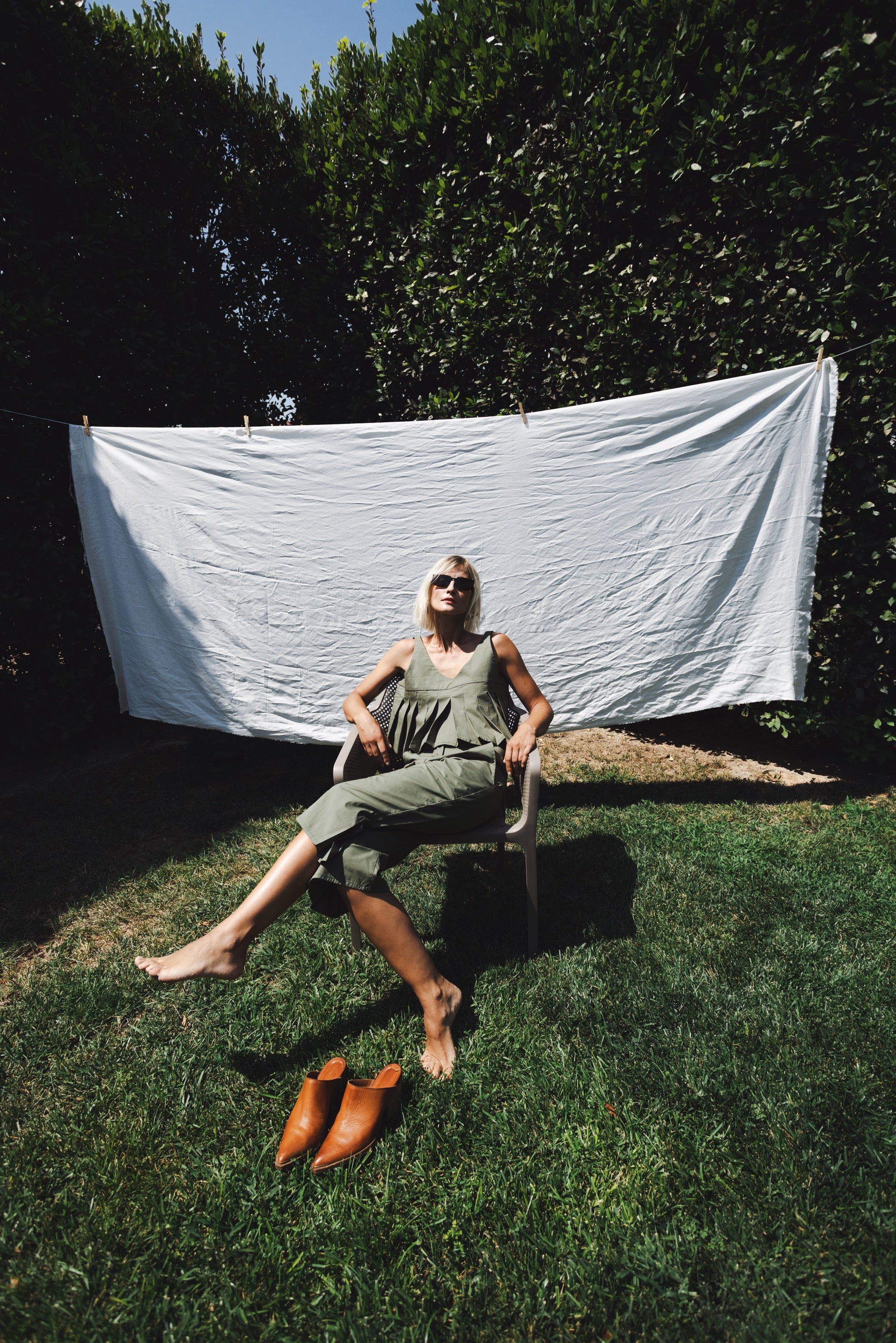 Julia Valas Elia Top with olive capri trousers matching set in relaxed garden setting under sunlight