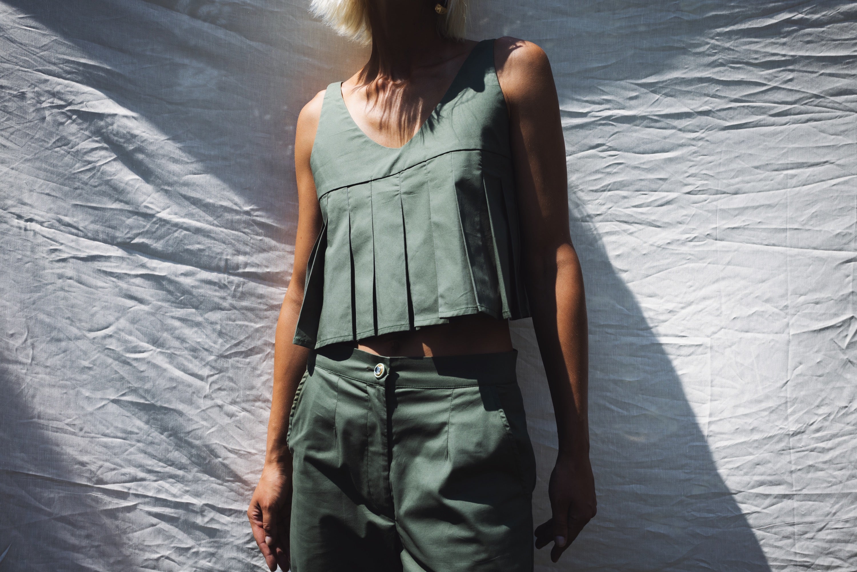 Julia Valas Elia Top olive pleated crop top detail in natural sunlight showing texture and silhouette