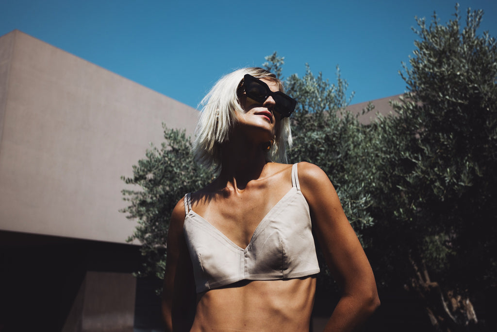 Julia Valas Halo bralette in beige cotton, double-layer design with thin straps, worn under sunlight outdoors