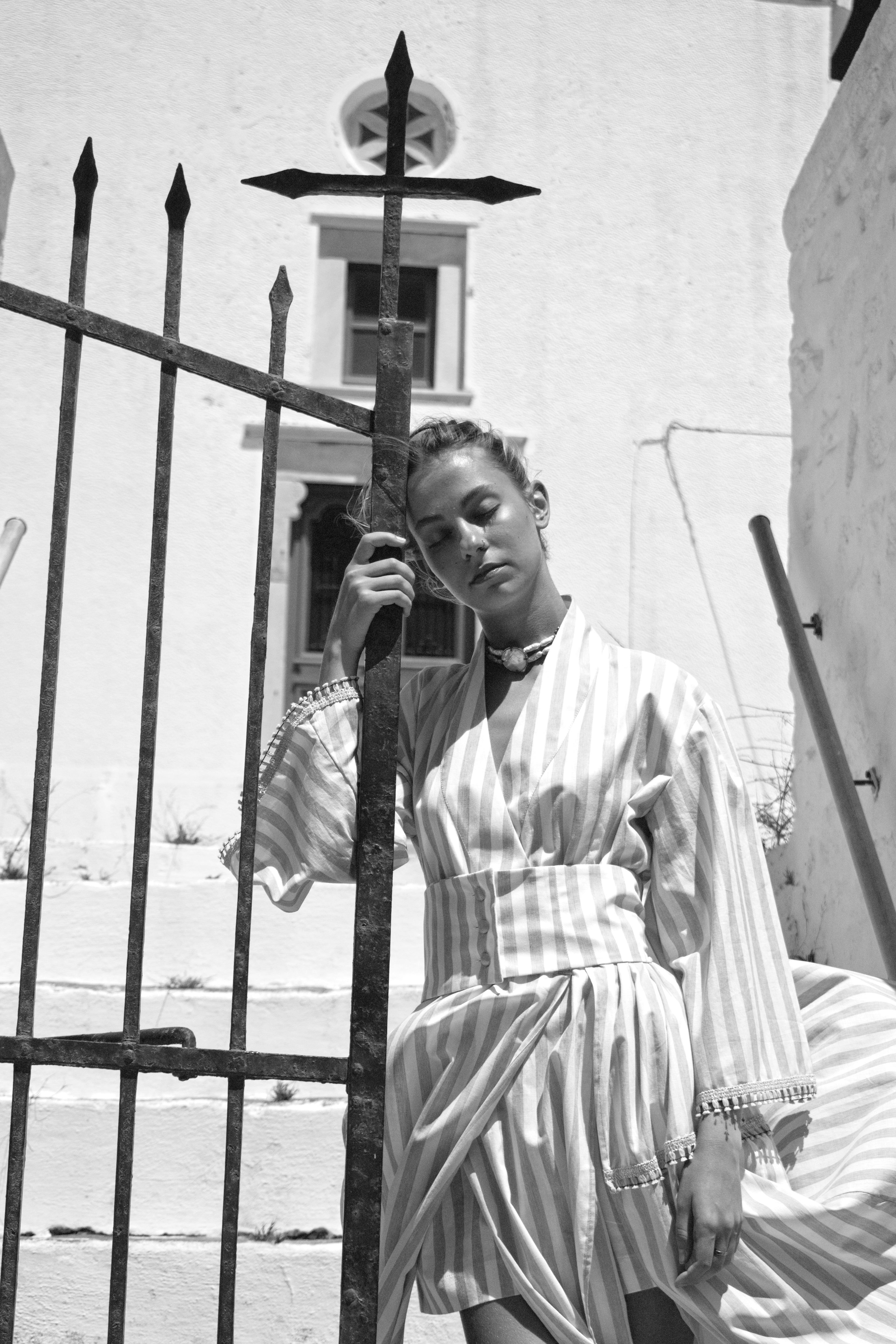 Editorial portrait of a model wearing the Julia Valas Hour Kimono Dress in Sand Stripe cotton in Syros, Greece.