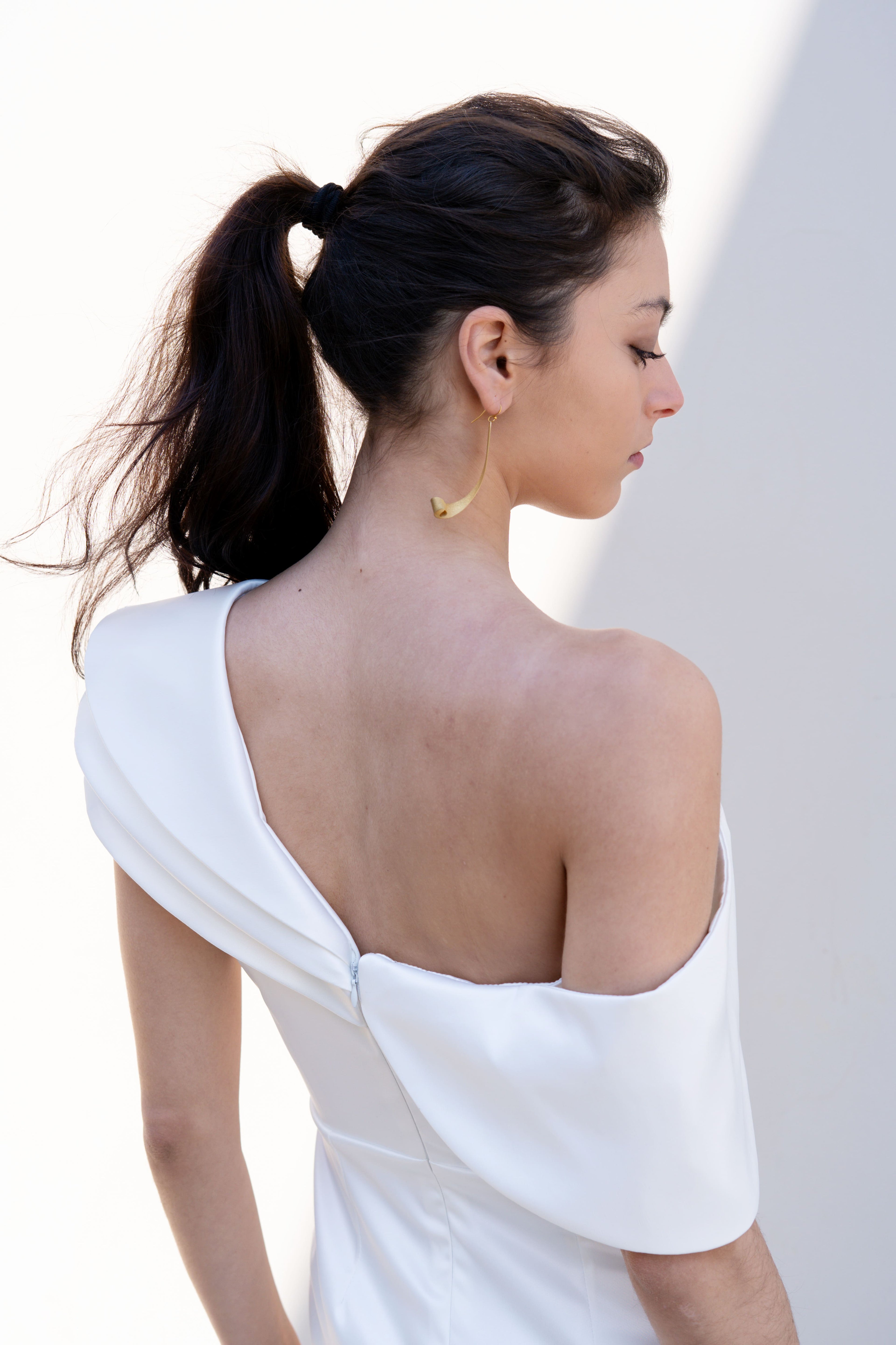 one-shoulder bridal gown open back detail with deconstructed neckline