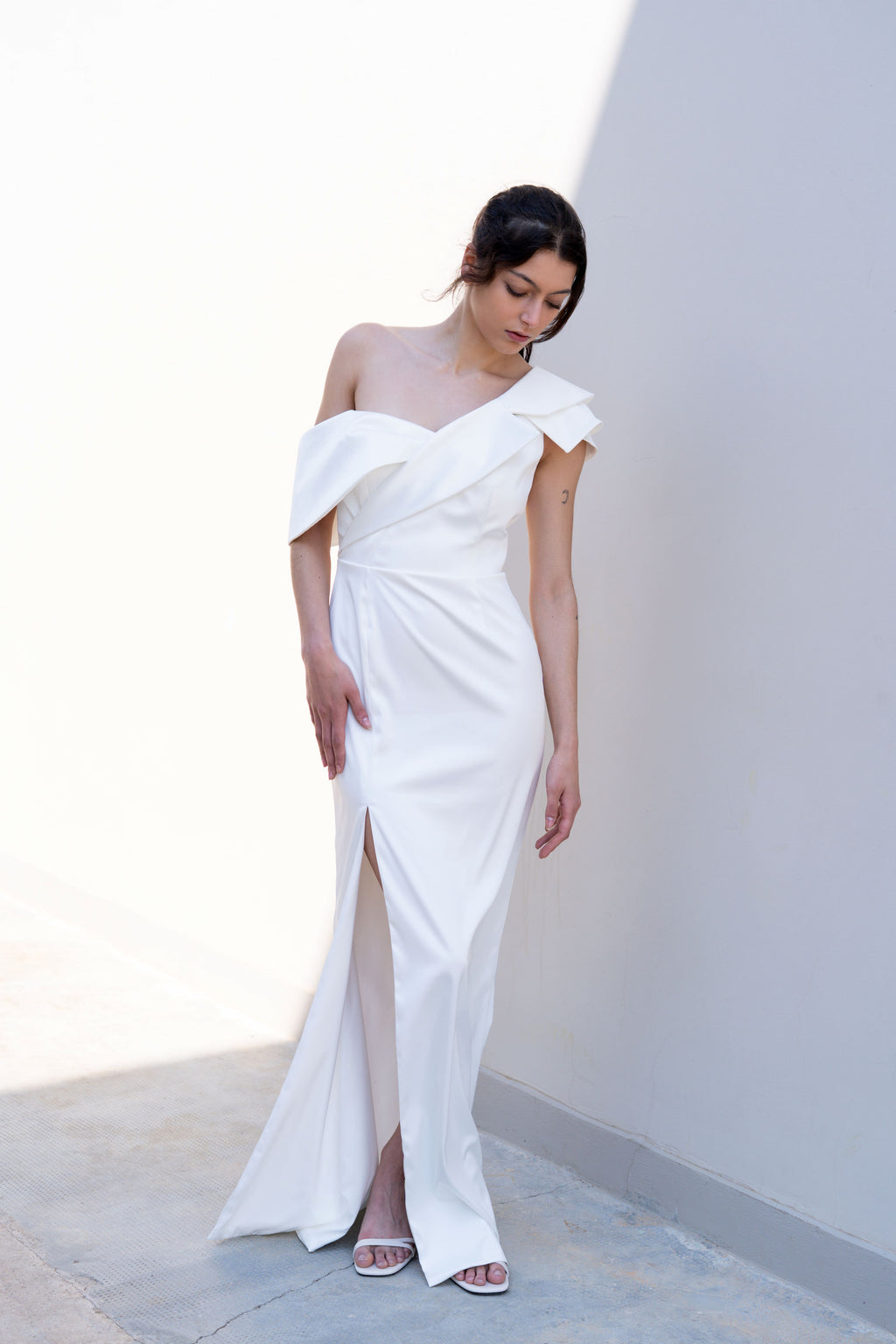 one-shoulder bridal gown with deconstructed lapel neckline and front slit mermaid silhouette