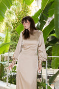 Open Flow midi dress in silk-blend fabric with long sleeves and fluid silhouette, model standing outdoors surrounded by lush greenery, Julia Valas