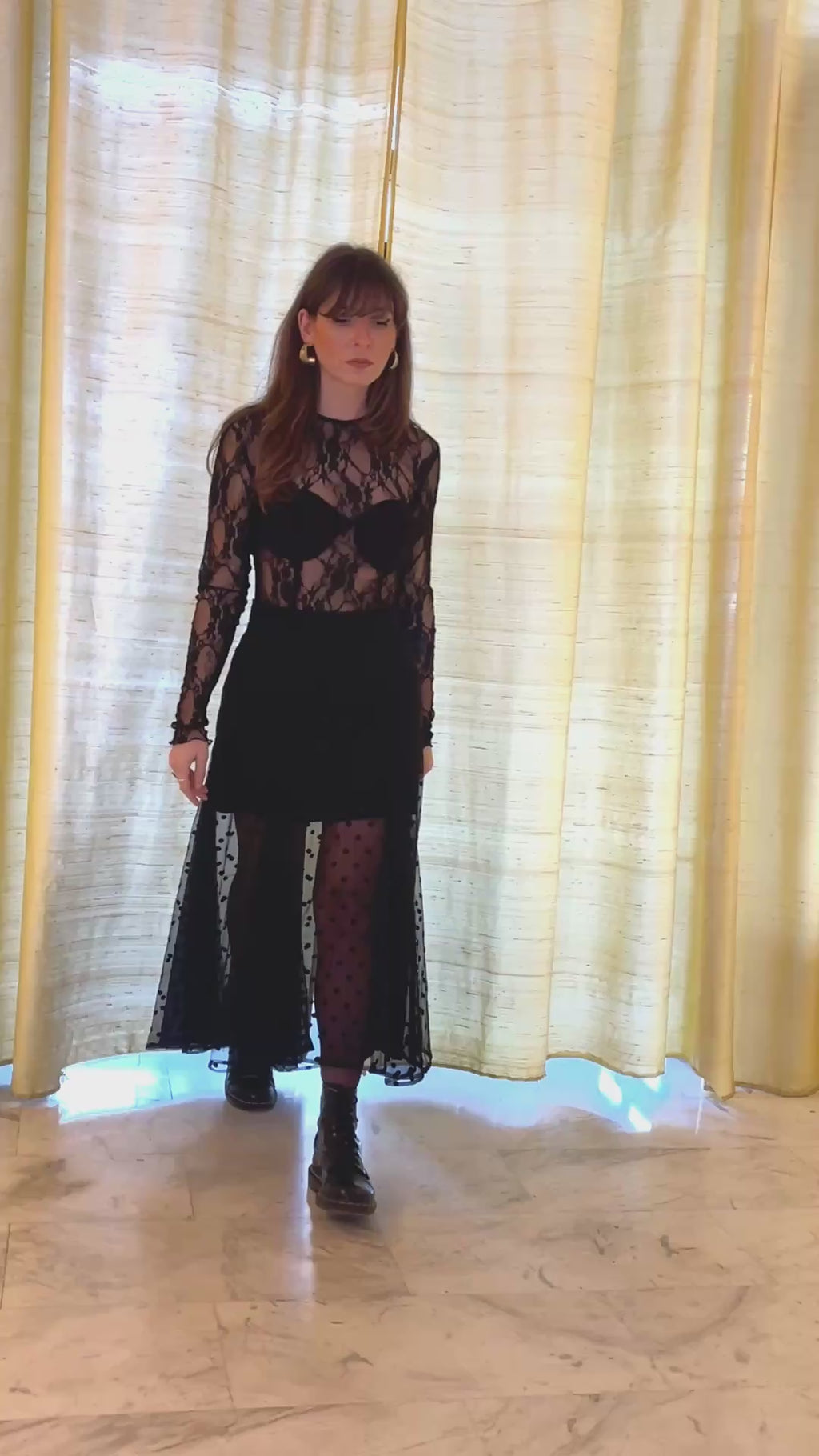 model walking and sitting in sunlight wearing black sheer tulle skirt with embroidered polka dots lace top Julia Valas