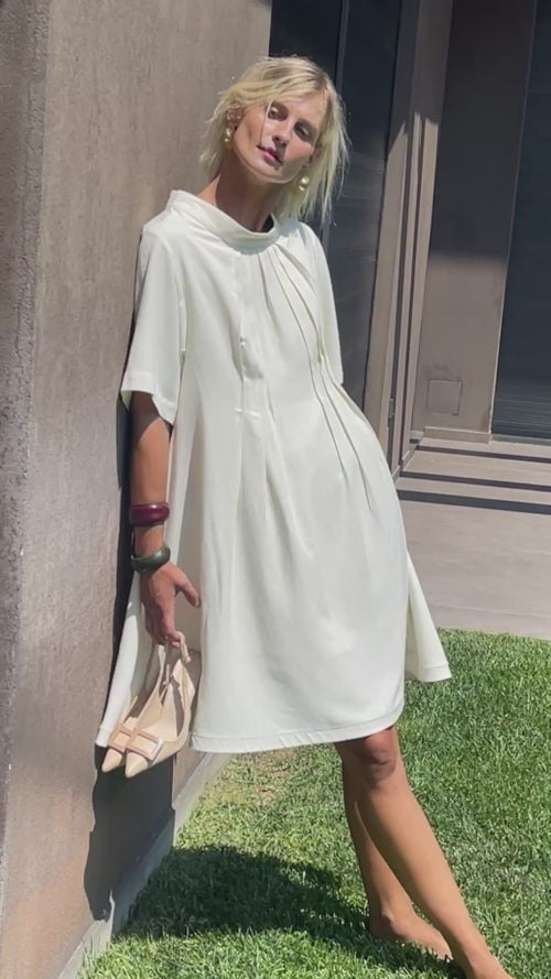 Cream linen-cotton dress in motion, showcasing flow and silhouette while walking
