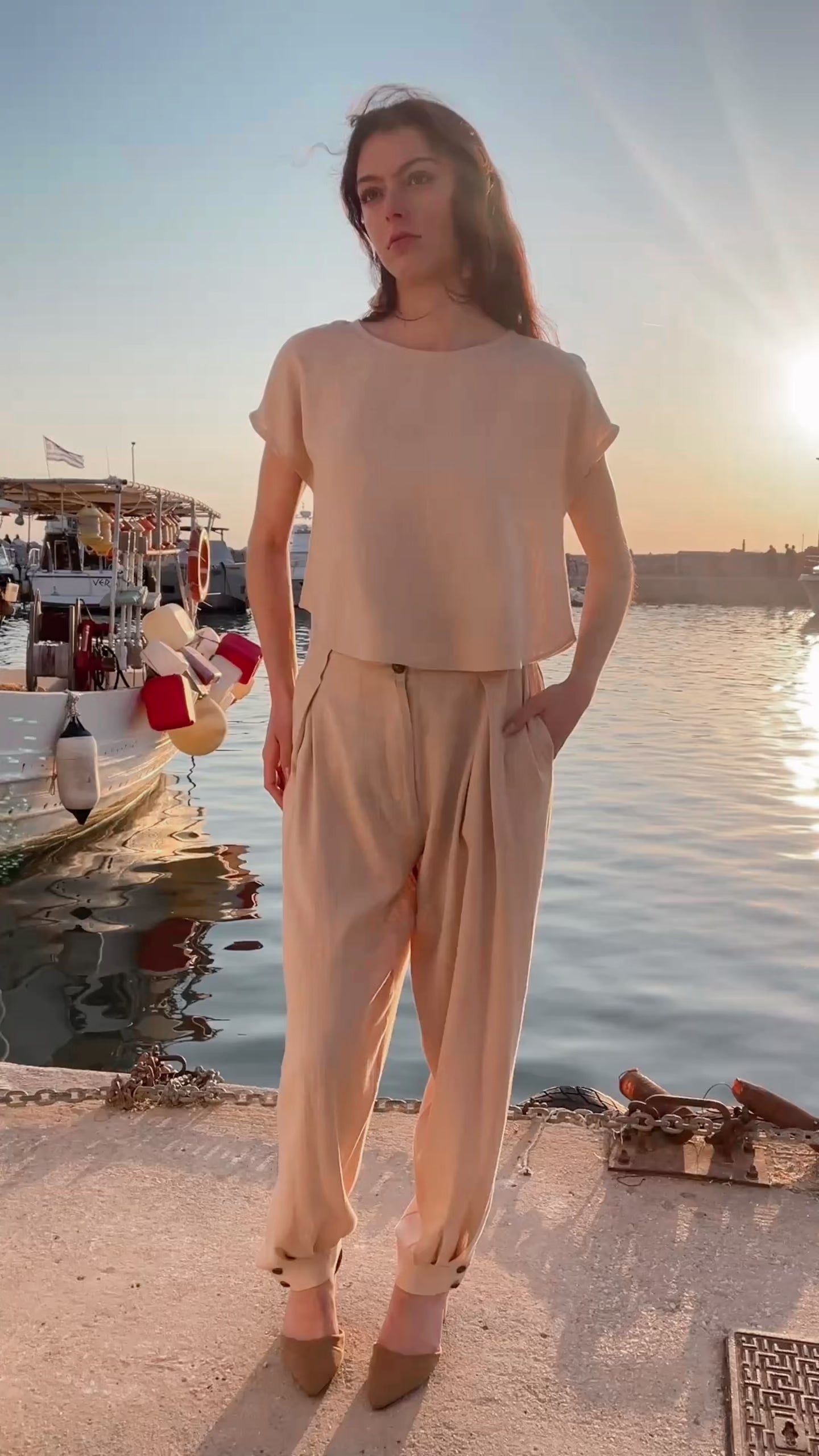 Minimal linen viscose cropped top styled sleeveless with detachable ruffle sleeves removed, relaxed summer silhouette paired with pleated loose trousers by Julia Valas, Video.
