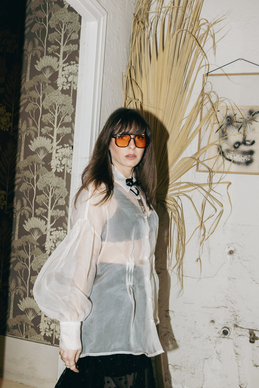 Sheer silk organza shirt with bishop sleeves and pearl buttons, styled with black polka dot skirt, side view, Julia Valas