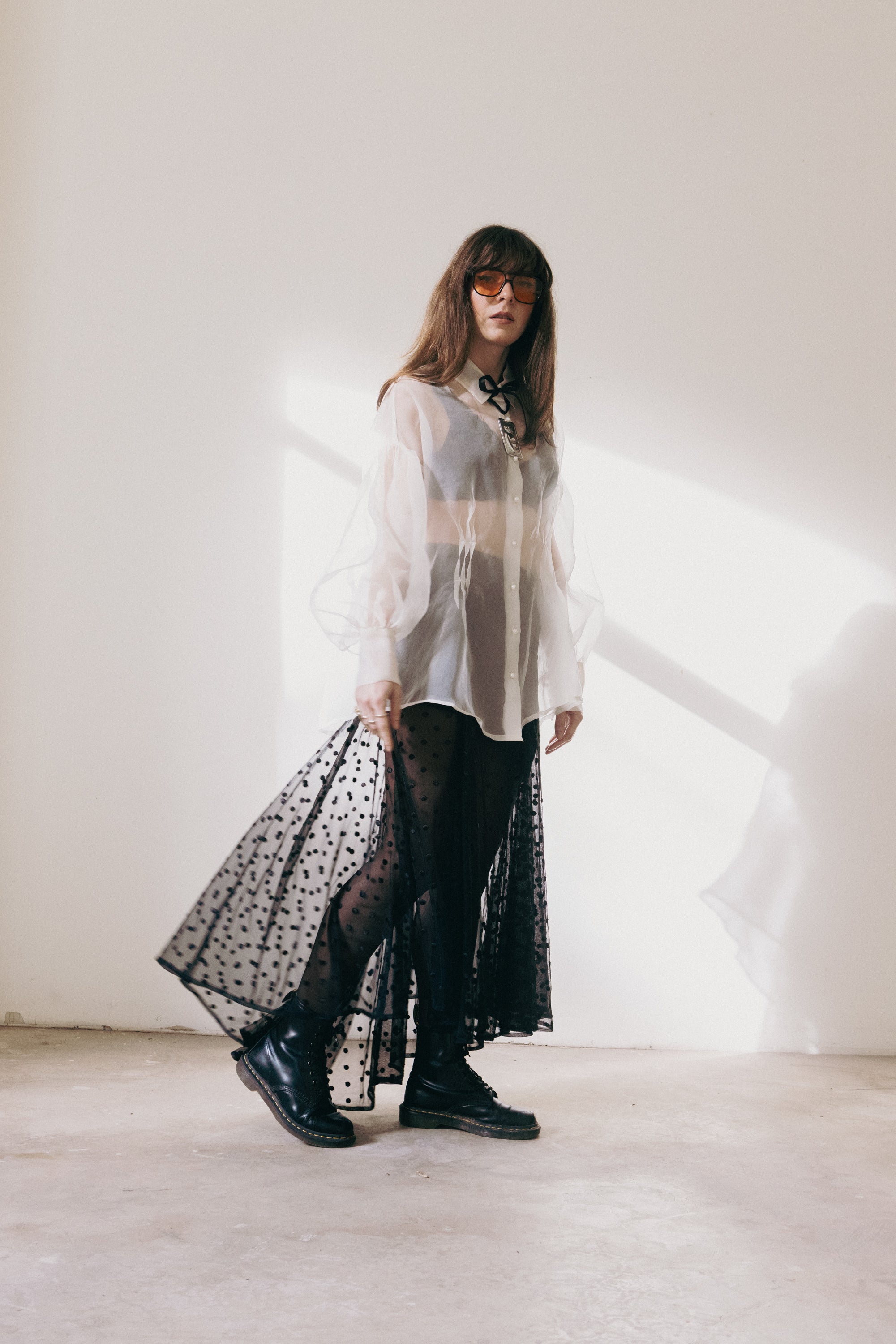 Sheer black polka dot skirt in motion with layered transparency, styled with silk organza shirt and boots, movement shot, Julia Valas