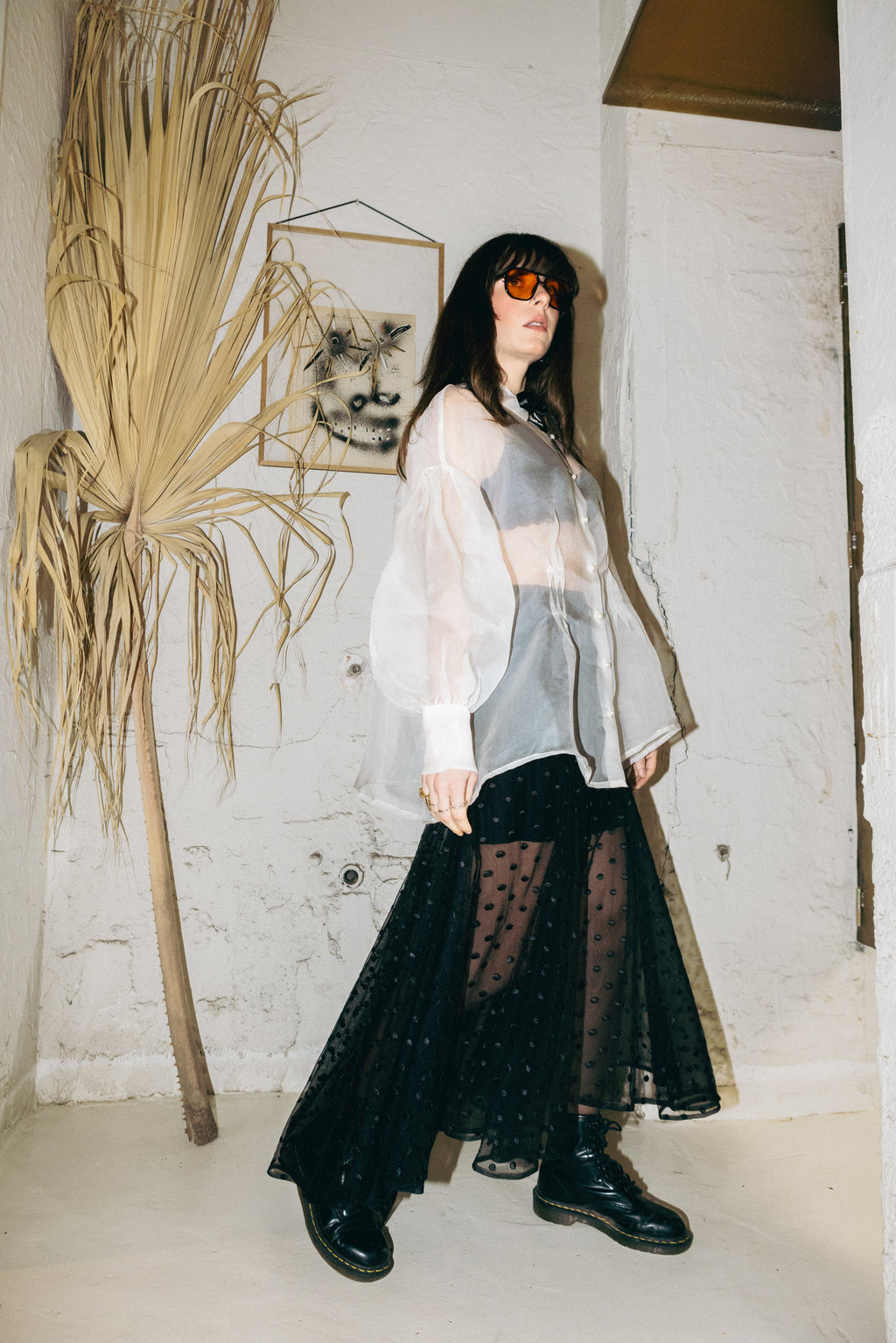 model wearing black polka dot tulle skirt with sheer organza shirt and boots Julia Valas