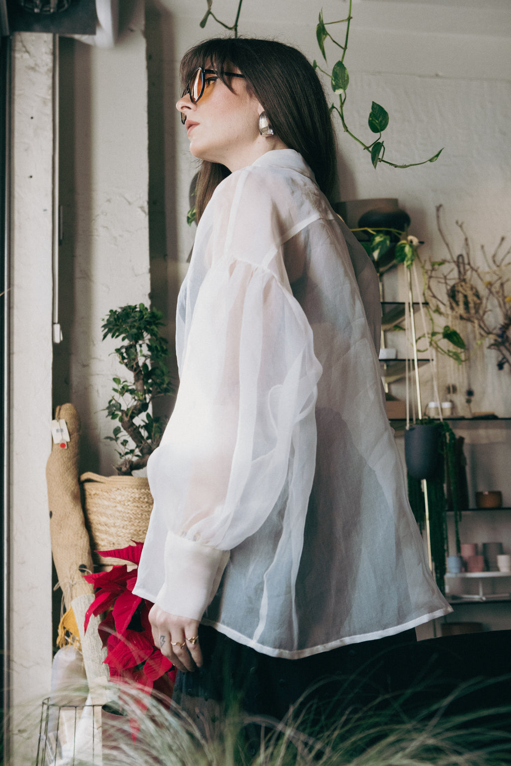 Close-up side view of sheer silk organza shirt with voluminous sleeves and structured silhouette, lightweight transparent fabric, Julia Valas